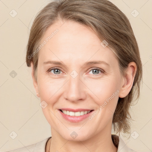 Joyful white adult female with medium  brown hair and grey eyes