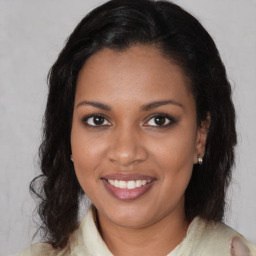 Joyful black young-adult female with medium  brown hair and brown eyes