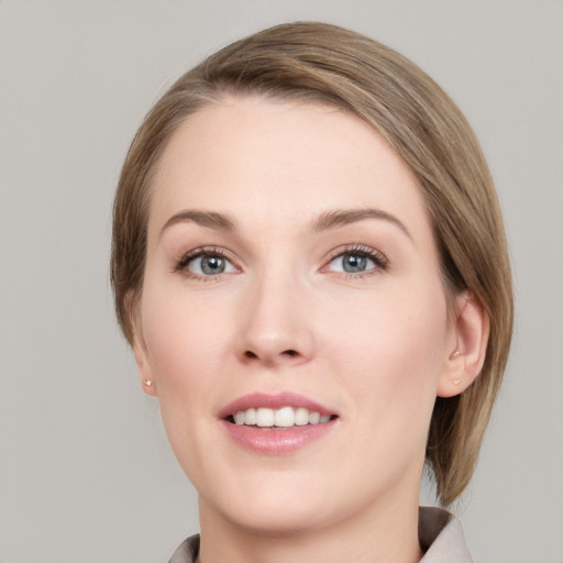 Joyful white young-adult female with medium  brown hair and grey eyes