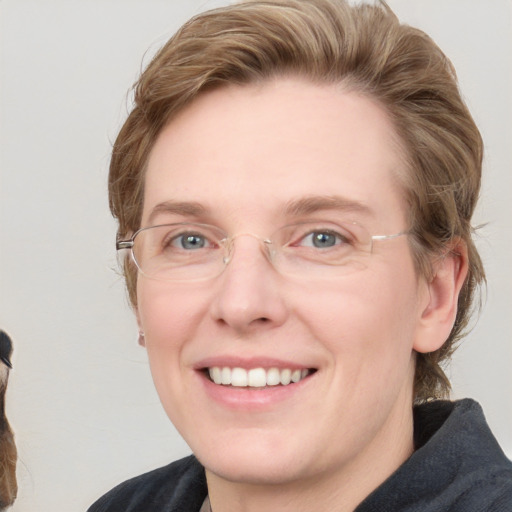 Joyful white adult female with medium  brown hair and blue eyes