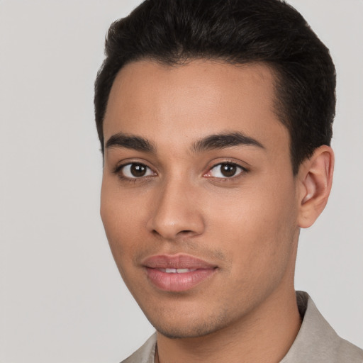 Joyful white young-adult male with short  black hair and brown eyes