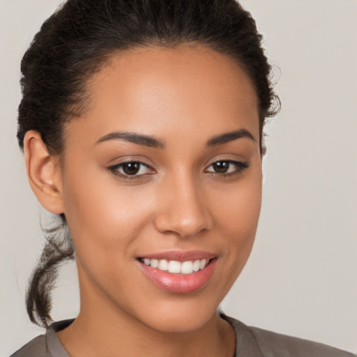 Joyful latino young-adult female with short  brown hair and brown eyes