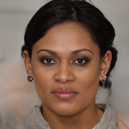Joyful black young-adult female with medium  black hair and brown eyes
