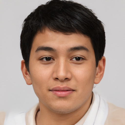 Joyful asian young-adult male with short  brown hair and brown eyes