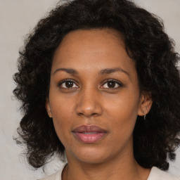 Joyful black adult female with medium  brown hair and brown eyes