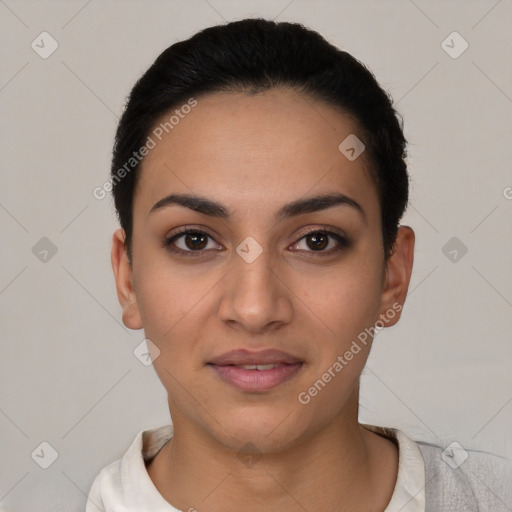 Joyful latino young-adult female with short  black hair and brown eyes