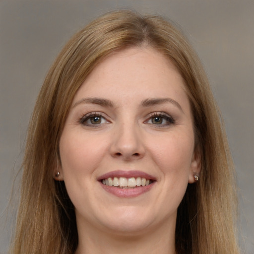 Joyful white young-adult female with long  brown hair and brown eyes