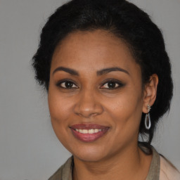 Joyful black young-adult female with medium  brown hair and brown eyes