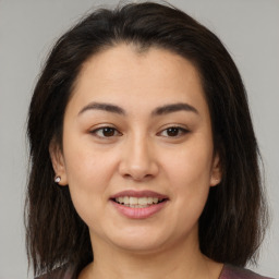 Joyful latino young-adult female with medium  brown hair and brown eyes