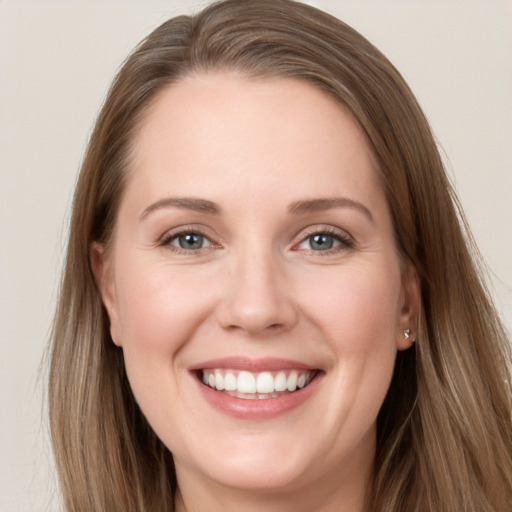 Joyful white young-adult female with long  brown hair and grey eyes