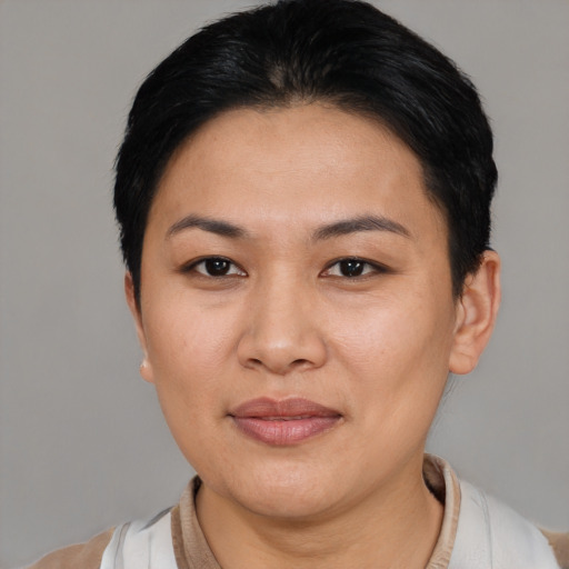 Joyful asian young-adult female with short  black hair and brown eyes