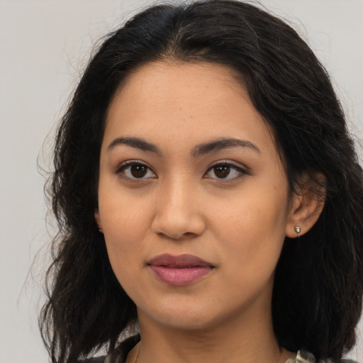 Joyful latino young-adult female with medium  brown hair and brown eyes