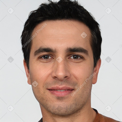 Joyful white young-adult male with short  black hair and brown eyes