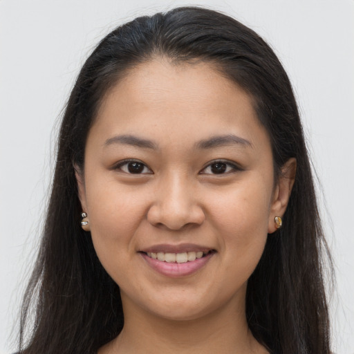Joyful latino young-adult female with long  brown hair and brown eyes
