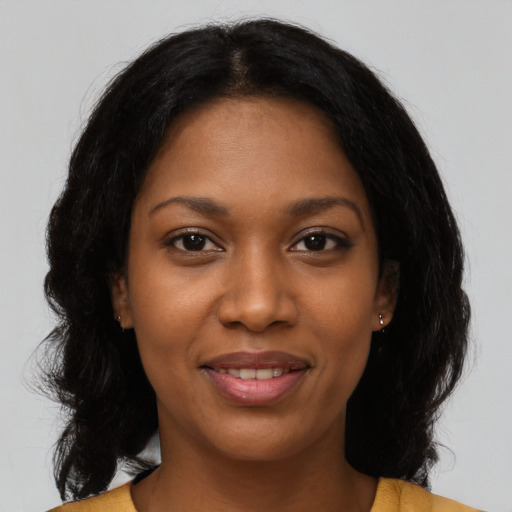 Joyful black young-adult female with medium  black hair and brown eyes