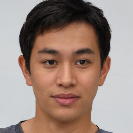 Joyful asian young-adult male with short  brown hair and brown eyes