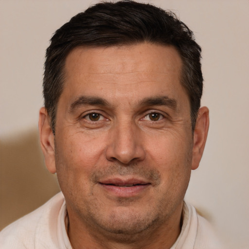 Joyful white adult male with short  brown hair and brown eyes