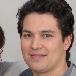 Joyful white young-adult male with medium  brown hair and brown eyes