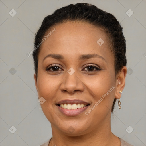 Joyful black adult female with short  brown hair and brown eyes