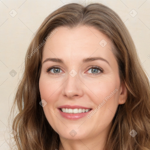 Joyful white young-adult female with long  brown hair and green eyes