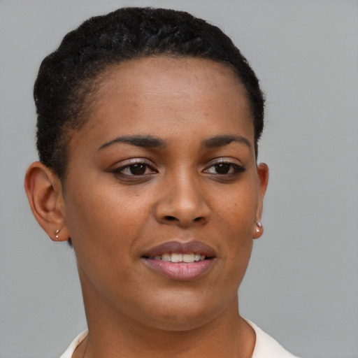 Joyful black young-adult female with short  brown hair and brown eyes