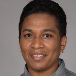 Joyful latino adult male with short  black hair and brown eyes