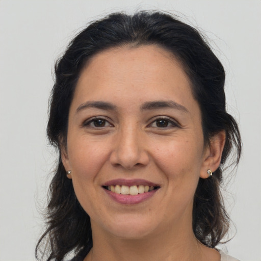 Joyful white adult female with medium  brown hair and brown eyes