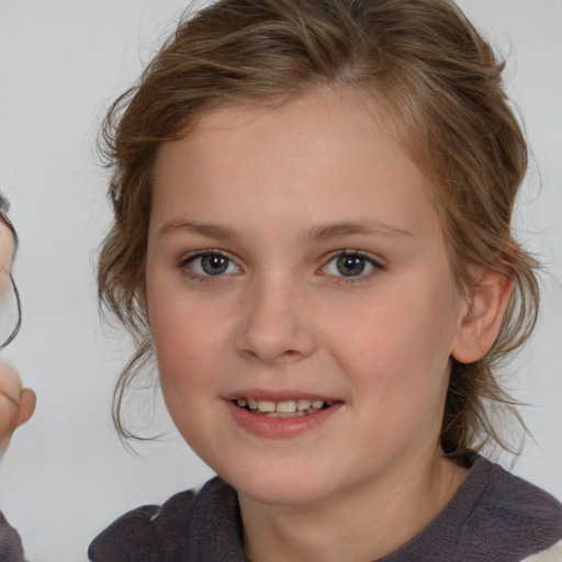 Joyful white child female with medium  brown hair and brown eyes