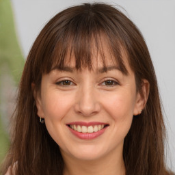 Joyful white adult female with long  brown hair and brown eyes