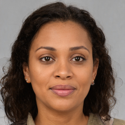 Joyful black young-adult female with medium  brown hair and brown eyes
