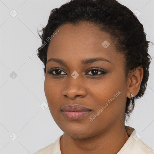 Joyful black young-adult female with short  black hair and brown eyes