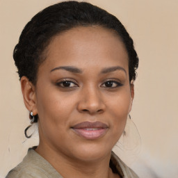 Joyful black young-adult female with medium  brown hair and brown eyes
