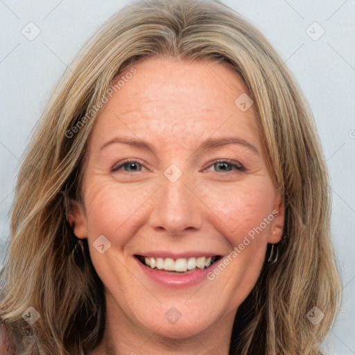 Joyful white adult female with long  brown hair and brown eyes