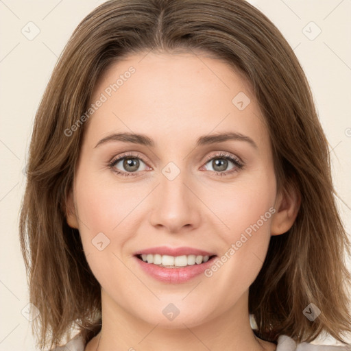 Joyful white young-adult female with long  brown hair and green eyes