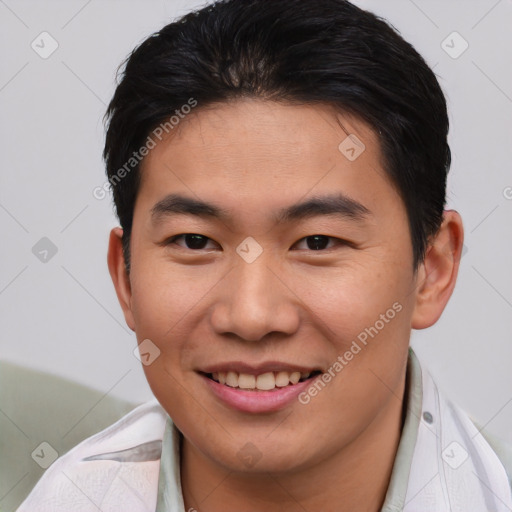 Joyful asian young-adult male with short  brown hair and brown eyes