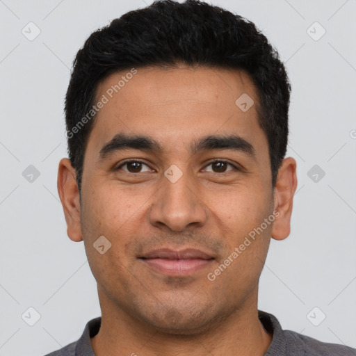 Joyful latino young-adult male with short  black hair and brown eyes