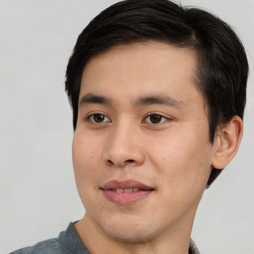 Joyful asian young-adult male with short  black hair and brown eyes