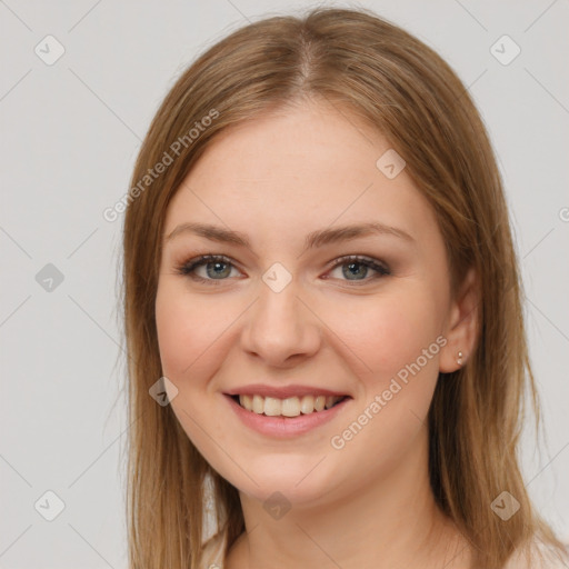 Joyful white young-adult female with long  brown hair and green eyes