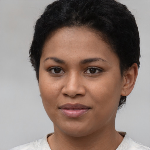 Joyful latino young-adult female with short  brown hair and brown eyes