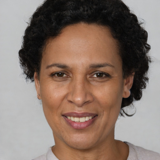 Joyful black adult female with short  brown hair and brown eyes
