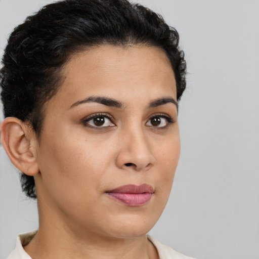 Joyful latino young-adult female with short  brown hair and brown eyes