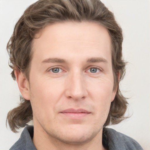 Joyful white adult male with medium  brown hair and grey eyes