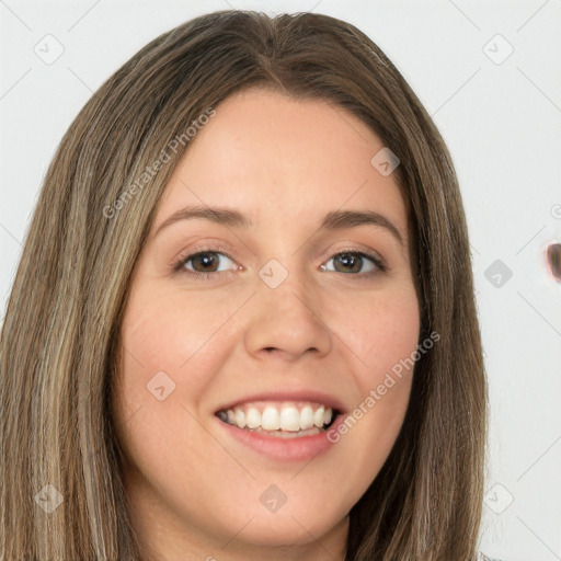 Joyful white young-adult female with long  brown hair and green eyes