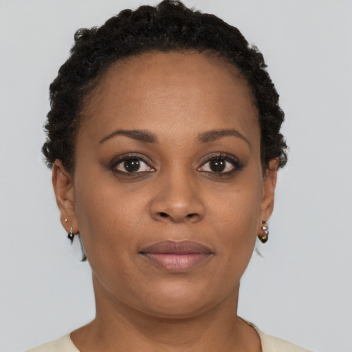 Joyful black young-adult female with short  brown hair and brown eyes