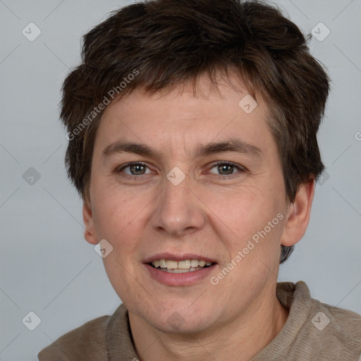 Joyful white adult male with short  brown hair and grey eyes