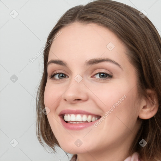 Joyful white young-adult female with medium  brown hair and blue eyes