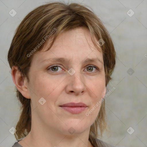 Joyful white adult female with medium  brown hair and grey eyes