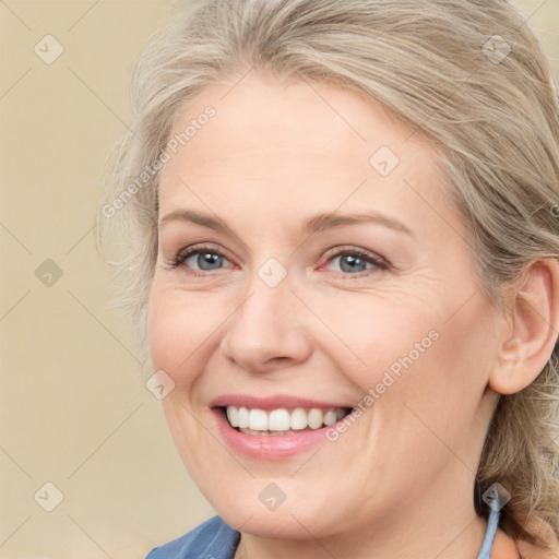 Joyful white adult female with medium  brown hair and blue eyes