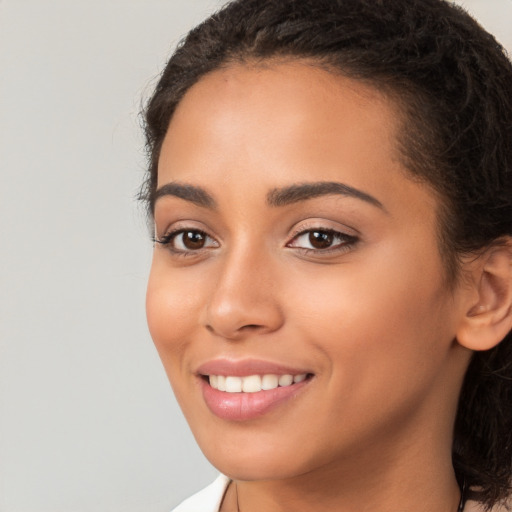 Joyful white young-adult female with long  brown hair and brown eyes