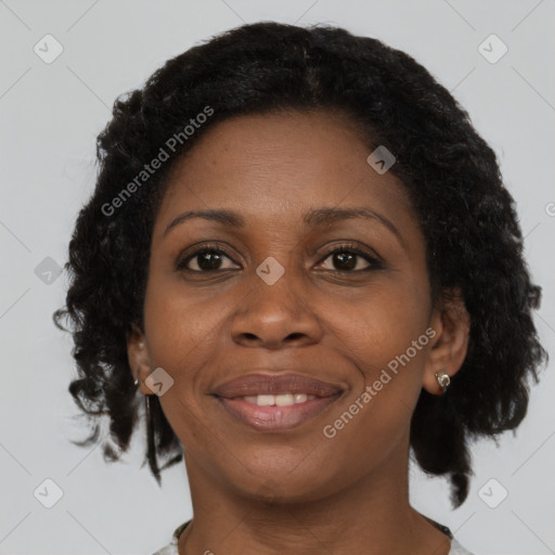 Joyful black adult female with short  brown hair and brown eyes